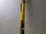 a yellow and black baseball bat sitting on top of a white table