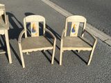 three wooden chairs sitting on the side of the road