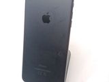 a black iphone that is sitting on top of a stand