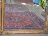 a large mirror sitting on the floor next to a rug
