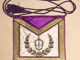 an image of a purple and gold cross on a purple and gold bag