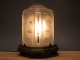 a lamp that is sitting on a wooden table