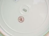 a white plate with a red and blue design on it