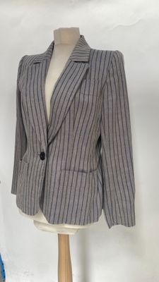 a suit on a mannequin stand with a stuffed animal