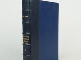 a blue book sitting on top of a white surface