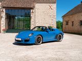 a blue car that is parked in front of a building