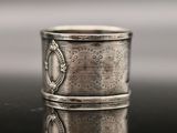 a close up of a silver ring on a reflective surface