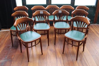 eight chairs in a circle on a wooden floor