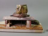 a figurine of a shoe on a bench