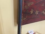 painting on the wall of a living room with a couch and a table