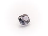 a close up of a diamond on a white surface