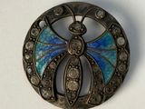 silver broochle with blue and white enamel butterfly in center