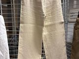 two men ' s pants hanging on a rack in a clothing store