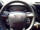 a steering wheel and dashboard of a car in a parking lot