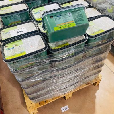 many containers of food sitting on a pallet in a store