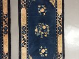 pair of oriental rugs with blue and yellow flowers and fringes
