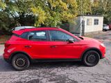 a picture of a red car parked in a parking lot