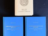 two books on a table with a black background and a blue book