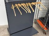 a rack with a bunch of wooden hangers on it