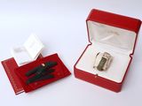 a red box with a pen and a black pen in it