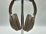 a pair of headphones on a stand on a white surface