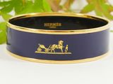 a close up of a bracelet with a horse drawn carriage on it