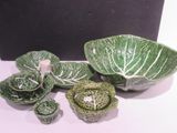 a bowl, bowl, plate, and bowl with cabbage leaves on it