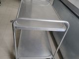 a metal cart that is sitting in the middle of a kitchen