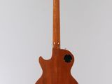 an electric guitar hanging from the ceiling in a room