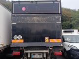 a truck that is parked in a lot with other trucks