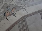 a painting of a man riding a horse on the wall
