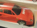 a red toy car that is in a box