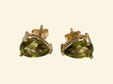 a pair of yellow gold earrings with peridot stones