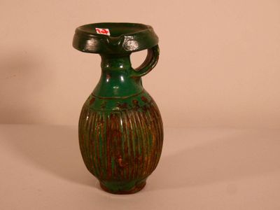 a green vase with a red tag on it