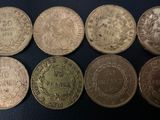 six different types of coins on a black surface