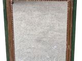 an old wooden picture frame with a green and gold border