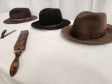 three hats on a table with a pair of scissors and a knife