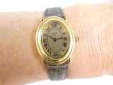 a gold wrist watch with roman numerals on it