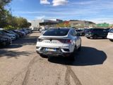 a white car parked in a parking lot with other cars