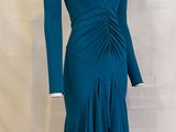 the dress is blue and has long sleeves and a v - neck