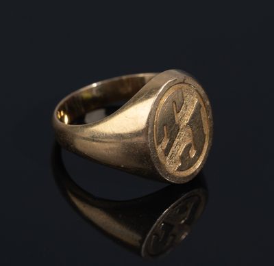 a gold signet ring with the initials of two men