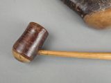 a hammer and a wooden mallet on a table