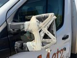 a white truck with a basket on the side of it