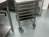 a kitchen with a lot of stainless steel items on the floor