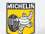 a michel tire sign on the side of a white truck