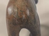 a small wooden bear figurine sitting on a table