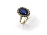 a close up of a ring with a blue stone on it