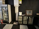 a black and white checkered floor with a refrigerator and freezer