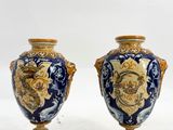 two vases that are sitting on a white surface