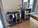 two coffee machines that are sitting on a table